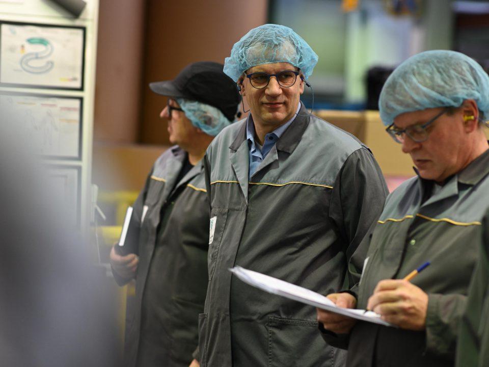 three male workers in hair nets